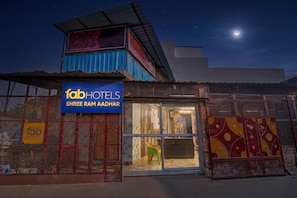 A hotel with a sign reading 'fabHOTELS SHREE RAM AADHAR' and a visible reception area.