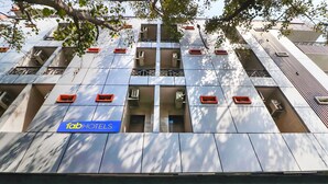 A modern hotel facade with multiple balconies, air conditioning units, and a sign for 'Tab Hotels'. - Fabhotel Starlight (New Delhi)