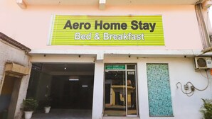 A building with a sign reading "Aero Home Stay Bed & Breakfast". - Fabexpress Gross Aero (New Delhi)