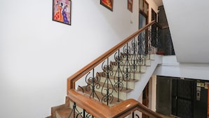 A staircase with ornate black railings and wooden steps.