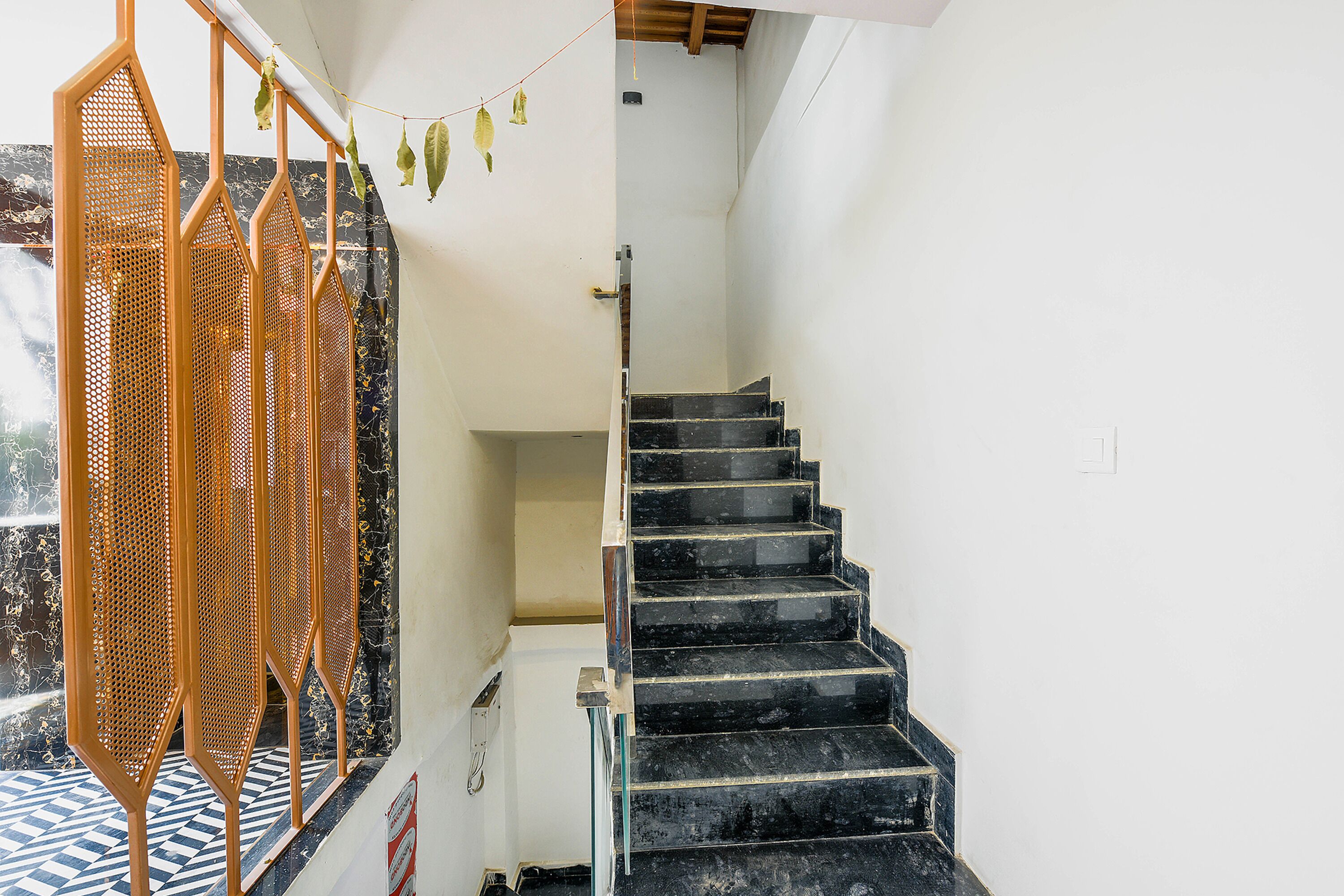 A staircase with black marble steps and a white wall.