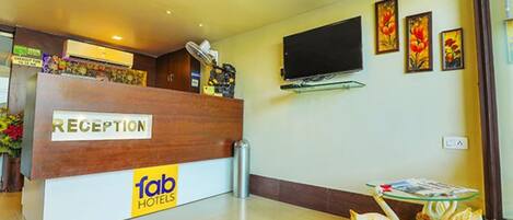 A reception desk with a 'Reception' sign and 'fab hotels' branding.