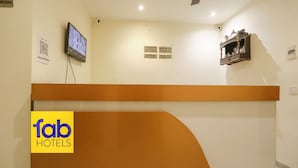 A hotel reception desk with a digital screen, a 'fab hotels' logo, and a 'no smoking' sign. - Fabexpress Baba'S Inn (New Delhi)