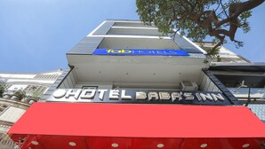 A hotel with a prominent red awning and signage for 'HOTEL BABASINN'. - Fabexpress Baba'S Inn (New Delhi)