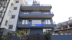 A multi-story building with a sign reading "Chef's House Home Stay" and "fabHOTELS". - Fabexpress Chef'S House (Gurugram)