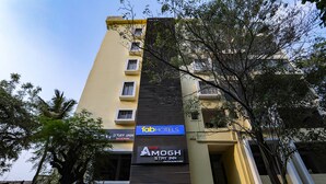 A multi-story hotel with signs for 'FabHotels' and 'Amogh Stay Inn'. - Fabhotel Amogh Stay Inn (Nagpur)