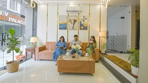 A modern lobby with a glass coffee table, a sofa, and a potted plant. - Fabhotel Relax Inn Palace (Haridwar)