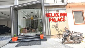 The entrance to a building with a sign reading "Relax Inn Palace". - Fabhotel Relax Inn Palace (Haridwar)
