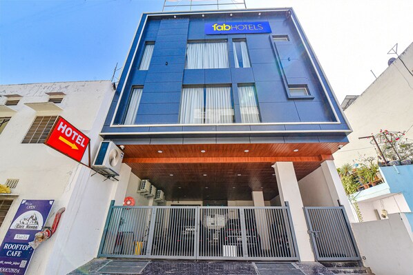 Experience the contemporary hotel's sleek entrance, complete with a gated entrance and rooftop cafe.
