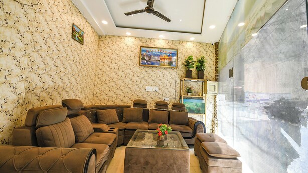 A living room with a sectional sofa, a glass coffee table, a ceiling fan, and a large window. - Fabexpress Galaxy (Kharar)