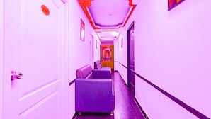 A hallway with a reception area, a sign reading "INDIA GATE," and a door with a security camera. - Fabexpress India Gate (Chennai)