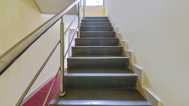 Eine Treppe mit Metallgeländern und einem roten Teppich.