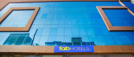 A modern hotel facade with a prominent 'fab hotels' sign.