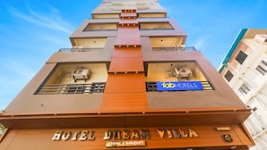 A hotel named "Hotel Dream Villa" with a modern design, featuring a prominent sign and a blue sign for "Fab Hotels". - Fabhotel Dream Palace (Danapur)
