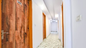 A hallway with wooden doors, numbered 406, and a patterned floor. - FabHotel PP Residency Tilak Nagar (New Delhi)