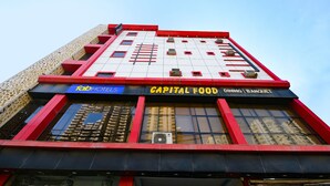 A building with a sign for "Capital Food Dining Banquet" and a "Tab Hotels" sign. - Fabhotel Capital Inn (Greater Noida)