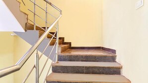 A staircase with metal railings and stone steps. - FabHotel Arambol Inn (Arambol)