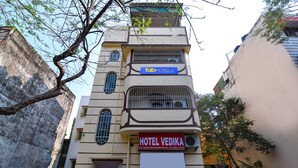 A multi-story building with a sign for 'Tab Hotels' and 'Hotel Vedika' indicating it is a hotel. - Fabexpress Vedika (Kolkata)