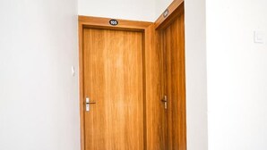 A wooden door with a number plate indicating room 105.