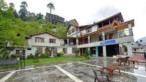 A hotel with a two-story structure, a balcony, and a signboard. - Fabhotel Attithi Huts And Cottage (Manali)