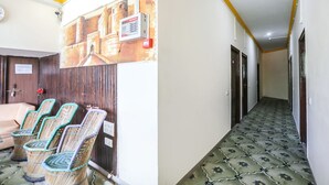 A hotel lobby with a reception area, a wall-mounted security camera, and a patterned floor. - Fabexpress Grand Resort (Agra)