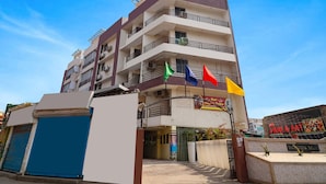 A multi-story building with a sign for 'Tab Hotels' and a restaurant named 'Mare & Eat'. - Fabhotel Magadh Palace (Danapur)