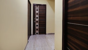 A hallway with a wooden door marked with the number 314, leading to a room. - Fabhotel Magadh Palace (Danapur)