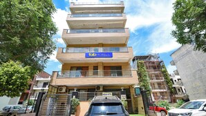 A multi-story hotel with a modern design, featuring balconies and large windows. - Fabhotel Indian (Gurugram)