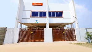 A two-story building with a sign reading "fabexpress" above the entrance. - Fabexpress Kovalam Residency (Tirupporur)