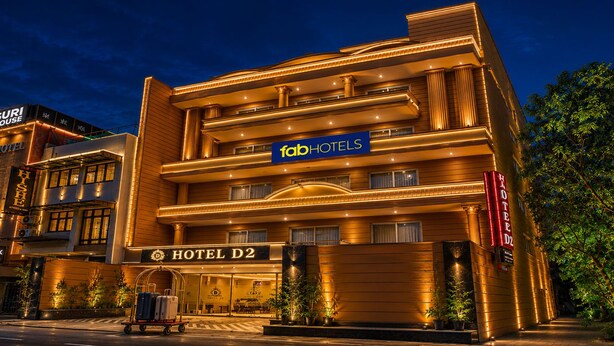 A multi-story hotel with a prominent 'fabHOTELS' sign, a 'HOTEL D2' label, and a luggage cart outside. - FabHotel D2 - Nr Ashok Vihar (New Delhi)