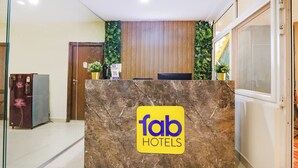 Ein Empfangstresen mit Marmorplatte und einem Schild mit der Aufschrift 'fab hotels'.