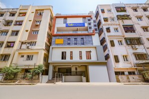 A multi-story building with a 'FabHotels' sign, featuring a modern facade with balconies and a central entrance. - FabHotel Starhood - Manikonda (Hyderabad)