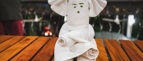 A towel sculpture on a wooden table.