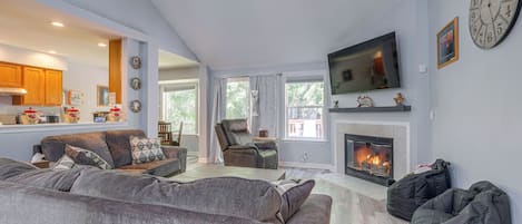 A living room with a fireplace, a television, and a sofa.