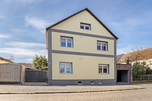 A two-story building with a flat roof and a symmetrical facade.