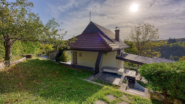 A small house with a sloped roof, a chimney, and a small porch. - Haven Near The River (Duga Resa)