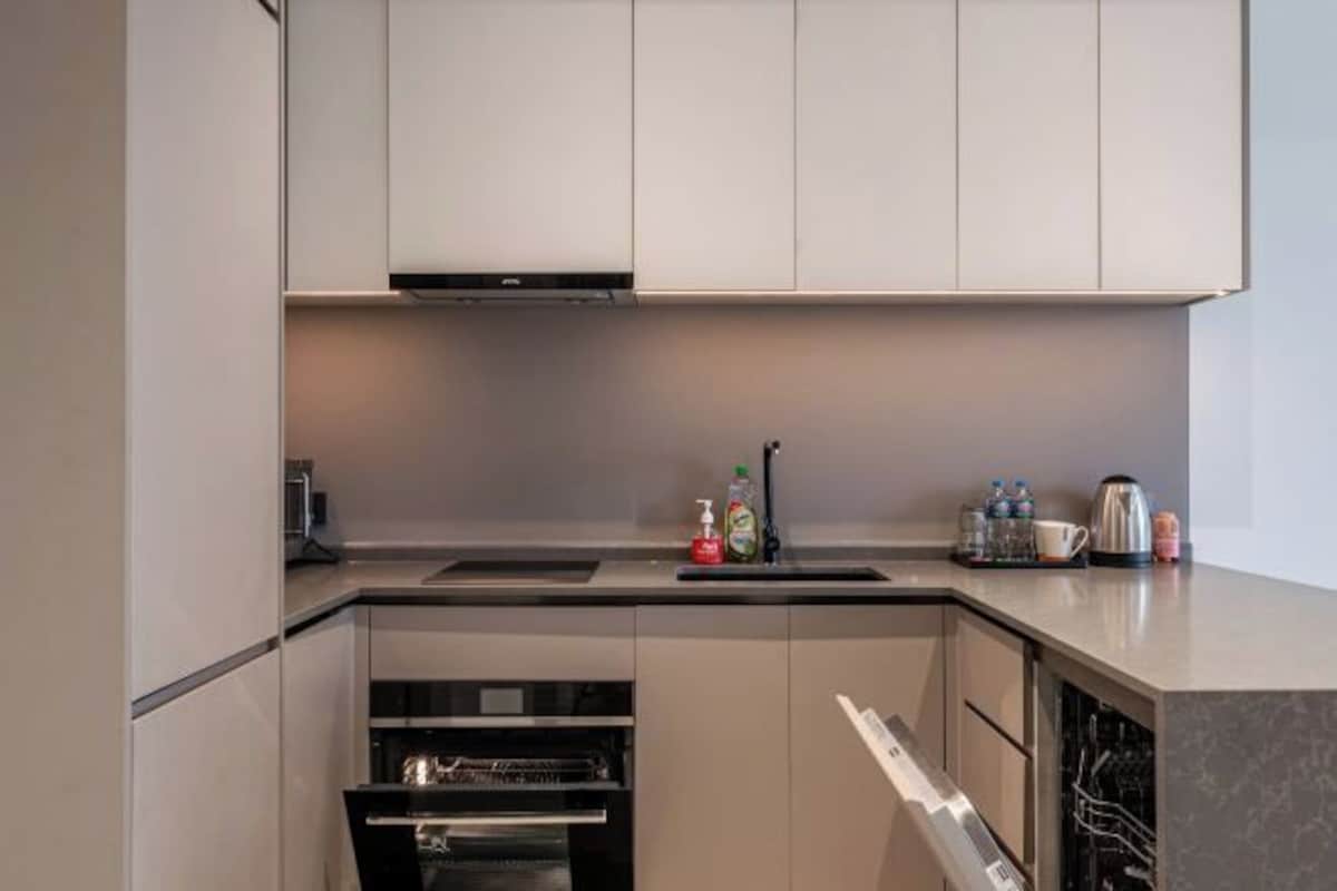 A modern kitchen with built-in appliances, a dishwasher, and a coffee maker.