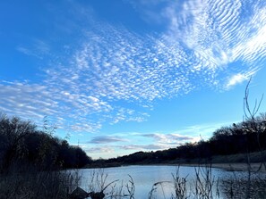 A river with a clear sky and scattered clouds.