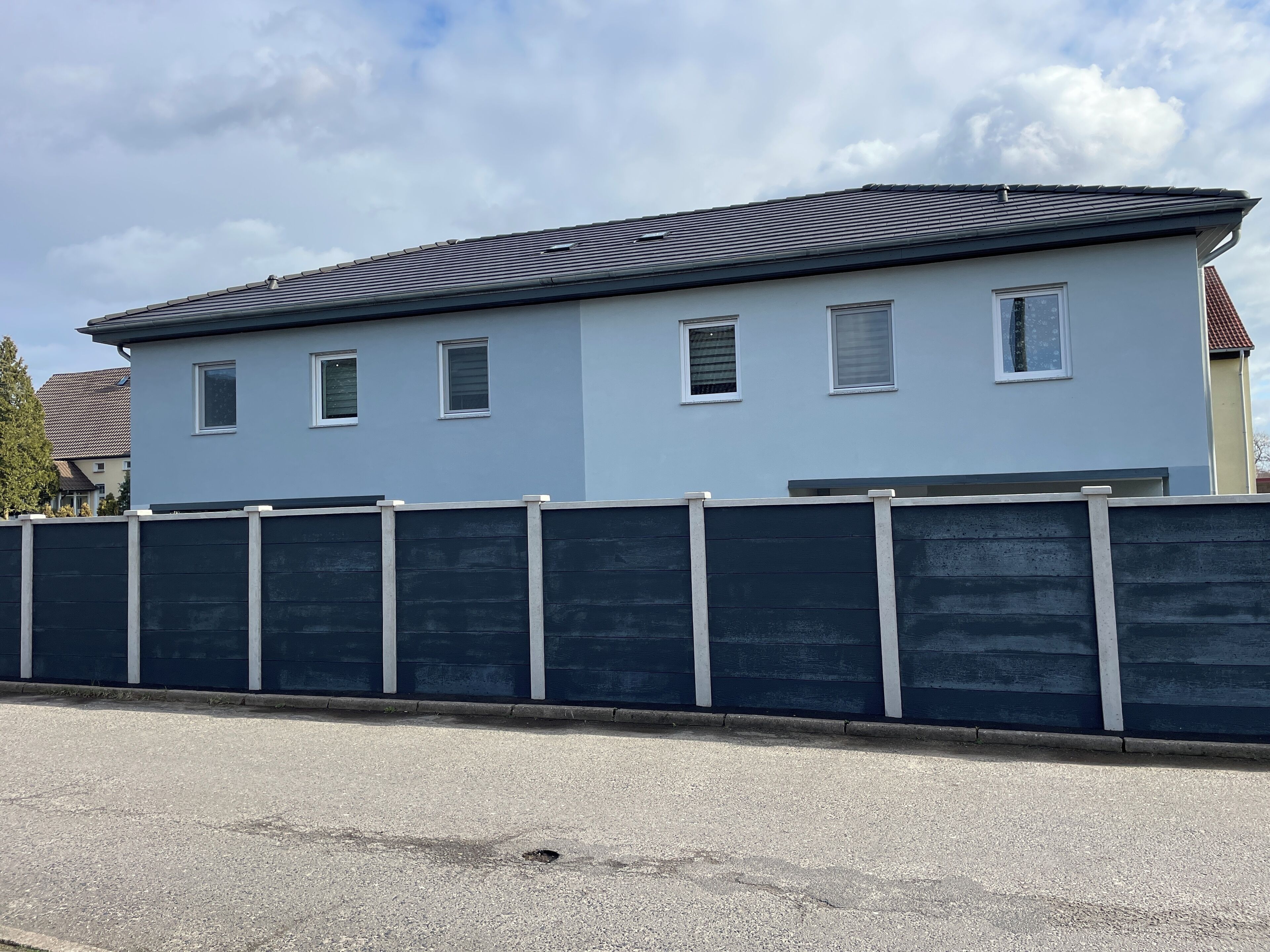 Un bâtiment à deux étages, doté d’un toit plat et de nombreuses fenêtres.