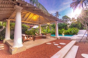 A covered outdoor area with a pool, seating, and a pergola structure. - Sattva Ahangama (Ahangama)