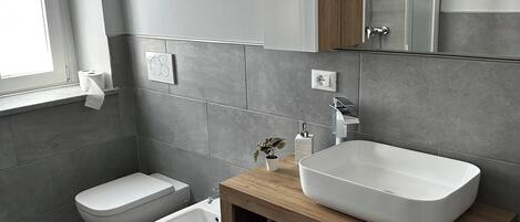 Een haardroger, handdoeken, zeep, toiletpapier