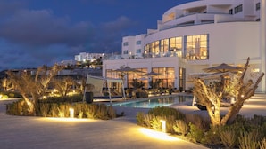 A modern hotel with a pool, outdoor seating, and a well-lit garden area. - Idou Malabata Beach and Spa (Tangier)