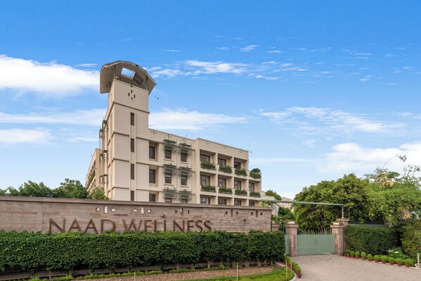 A building with a sign reading "NAAD WELLNESS" and a gated entrance. - Naad Wellness (Sonepat)