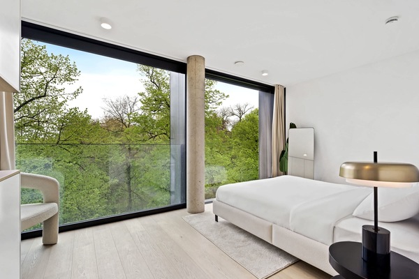 Wake up to lush greenery outside your window in our tranquil bedroom retreat.