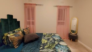 A bedroom with a bed, two windows with sheer curtains, a mirror, and a small stool. - Room-your Peaceful Haven, Unique Shared (Cape Town)