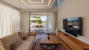 A modern living room with a sofa, coffee table, and TV.