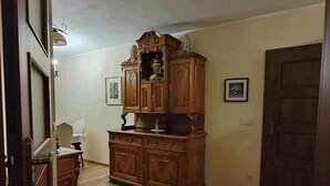 A room with a wooden cabinet, a chair, and a door. - 1bed Apartment - Sleeps 4 - Terrace, Pets, Parking (gmina Krasne)