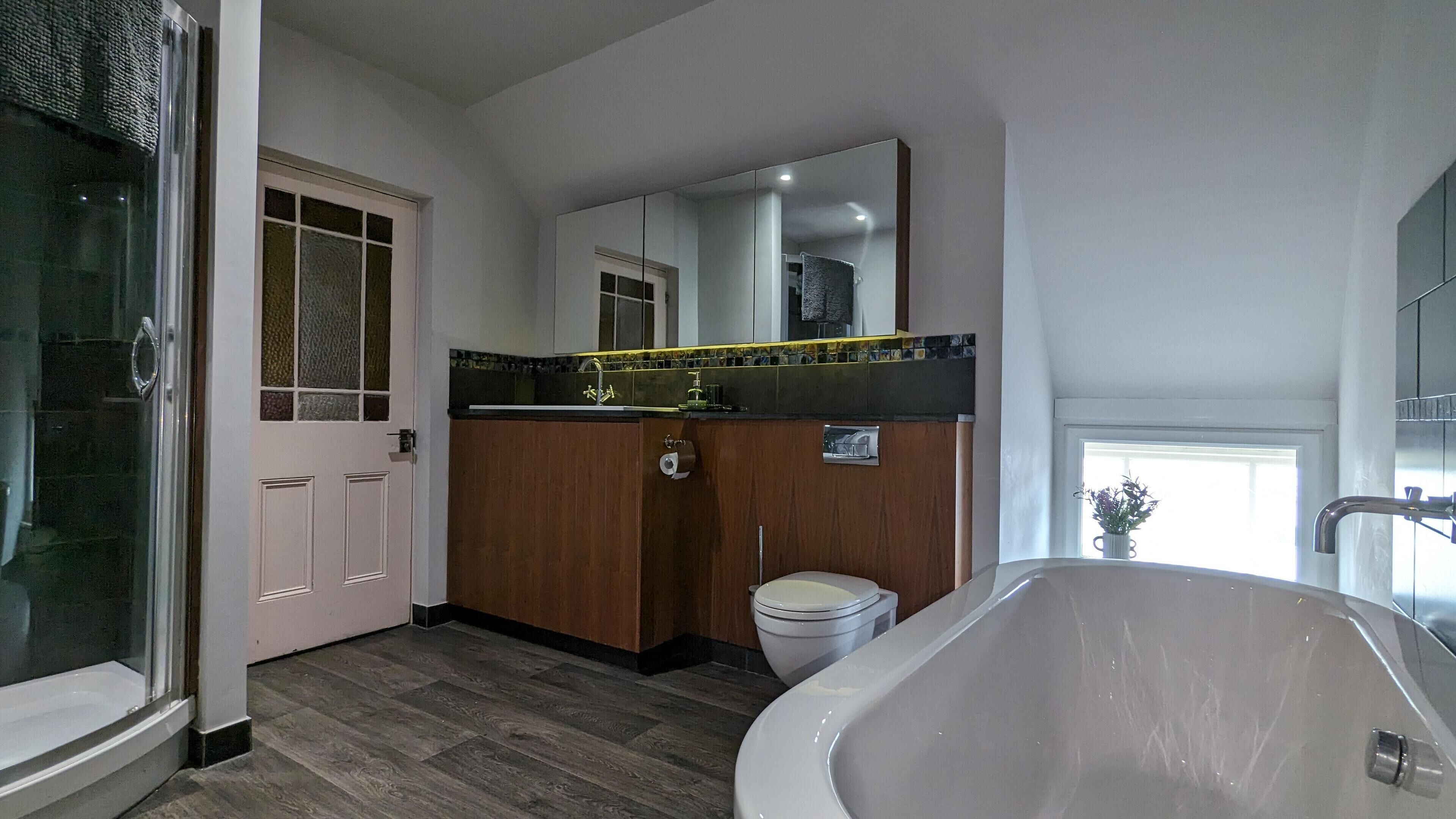 A bathroom with a bathtub, toilet, and sink.