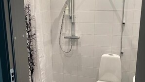 A small, modern bathroom with a shower, toilet, and a glass partition. - Ahlgrens Hotell Bed & Breakfast (Gävle)