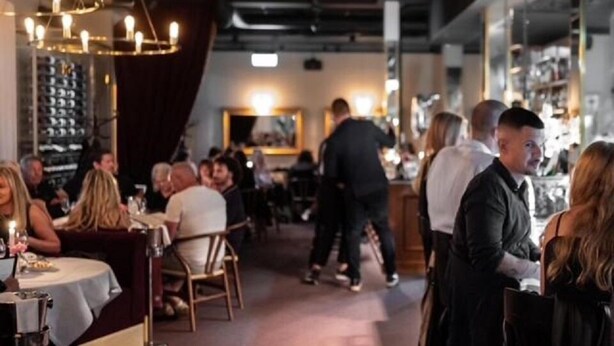 A restaurant interior with tables, chairs, and a bar area. - Ahlgrens Hotell Bed & Breakfast (Gävle)